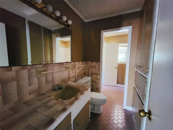 a bathroom with a toilet sink and mirror