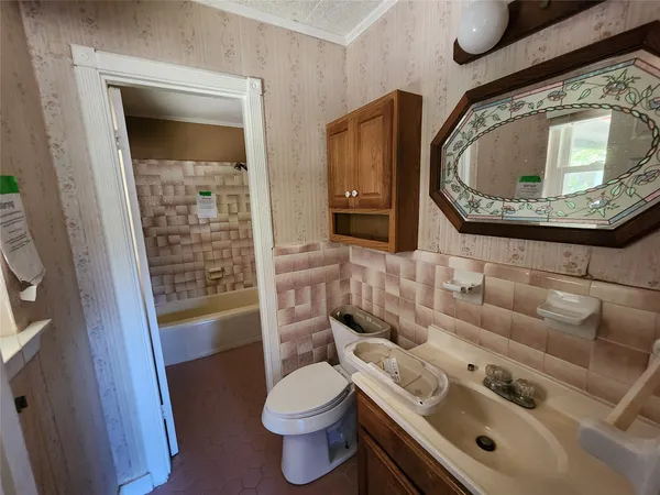 a bathroom with a sink and toilet