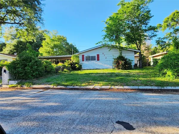 a view of a house with a yard and plants