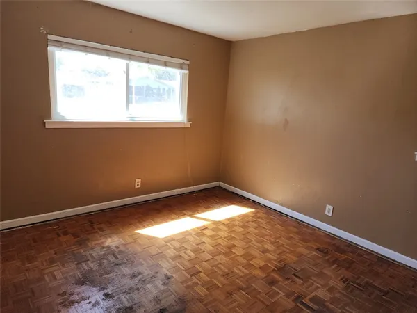 a front view of a house with a yard and potted plants