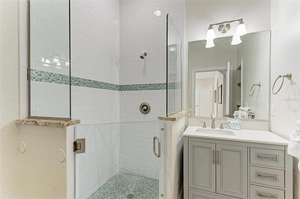 308 58th Street, Unit A Holmes Beach, FL 34217 - Photo 14 of 41 a bathroom with a double vanity sink mirror and double