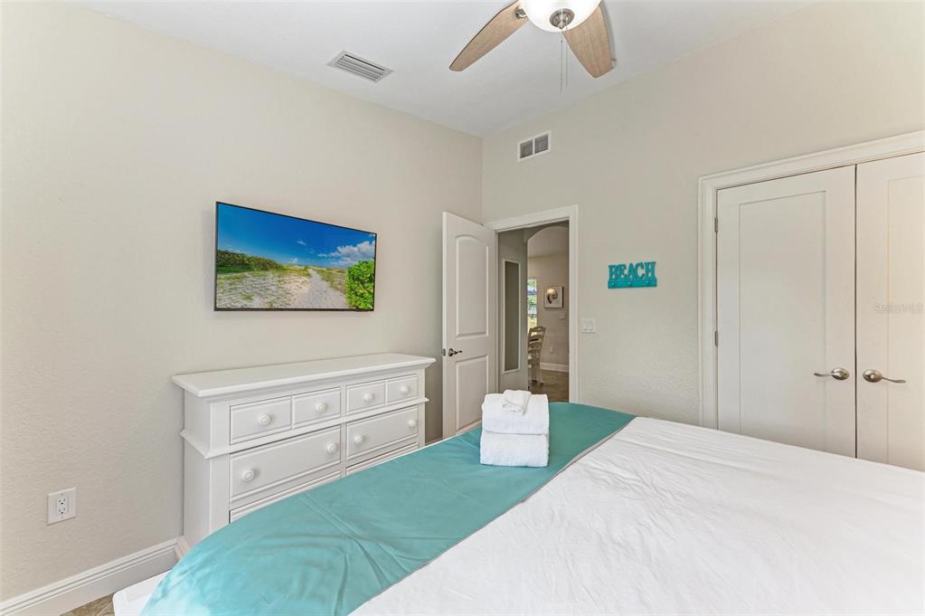 308 58th Street, Unit A Holmes Beach, FL 34217 - Photo 21 of 41 a spacious bedroom with a bed and a cabinets