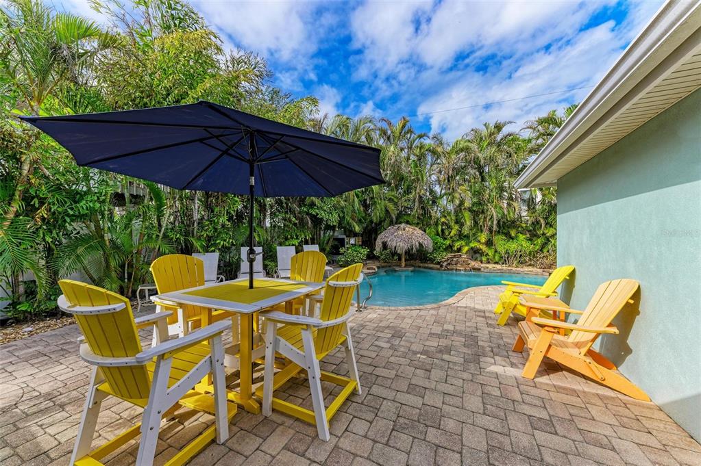 308 58th Street, Unit A Holmes Beach, FL 34217 - Photo 26 of 41 a patio with a patio table and chairs