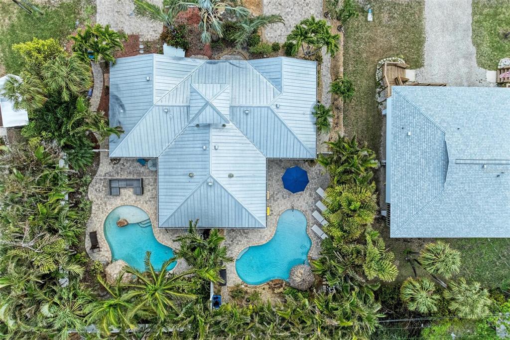 308 58th Street, Unit A Holmes Beach, FL 34217 - Photo 40 of 41 an aerial view of a house with garden space and street view