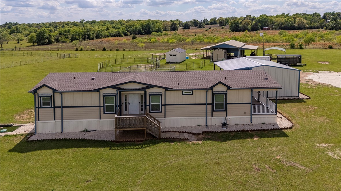 10976 Whiterock Road Bremond, TX 76629 - Photo 1 of 42 an aerial view of a house with a garden and lake view