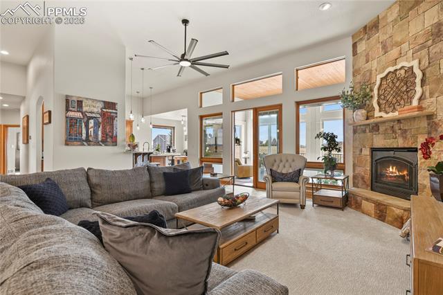 5220 Roundup Ridge Road Colorado Springs, CO 80908 - Photo 5 of 50 Main level great room with stone surround and gas fireplace