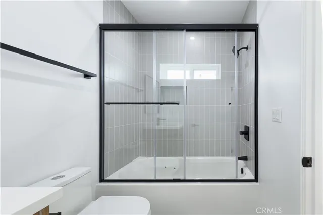 a bathroom with a glass shower door