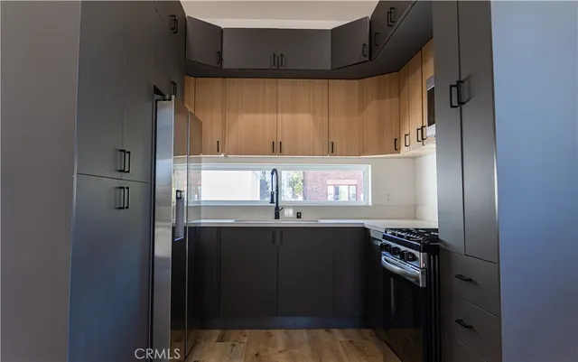 a kitchen with stainless steel appliances a sink and cabinets