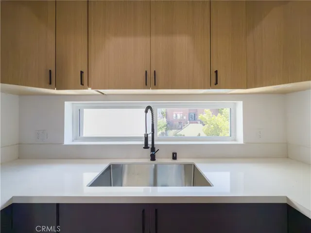 a kitchen with a sink and a window