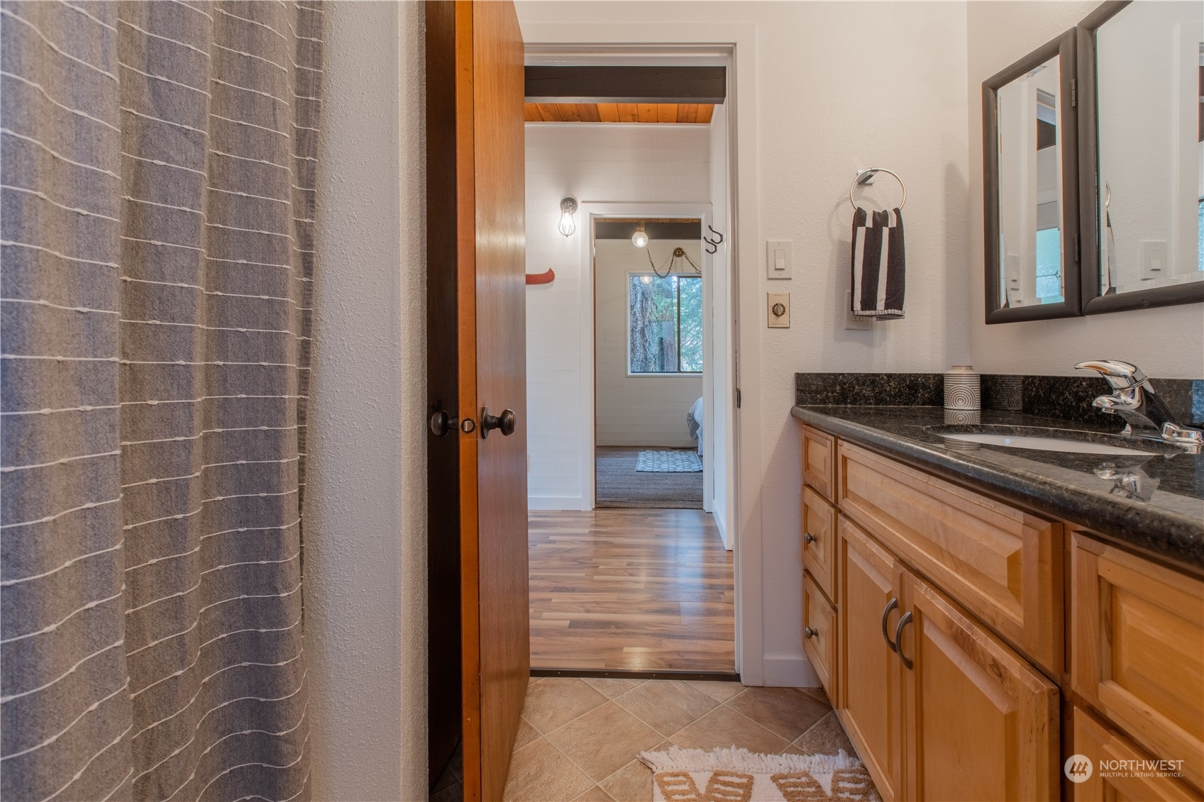 7736 View Ridge Drive Maple Falls, WA 98266 - Photo 16 of 25 a bathroom with a granite countertop sink a mirror and a shower