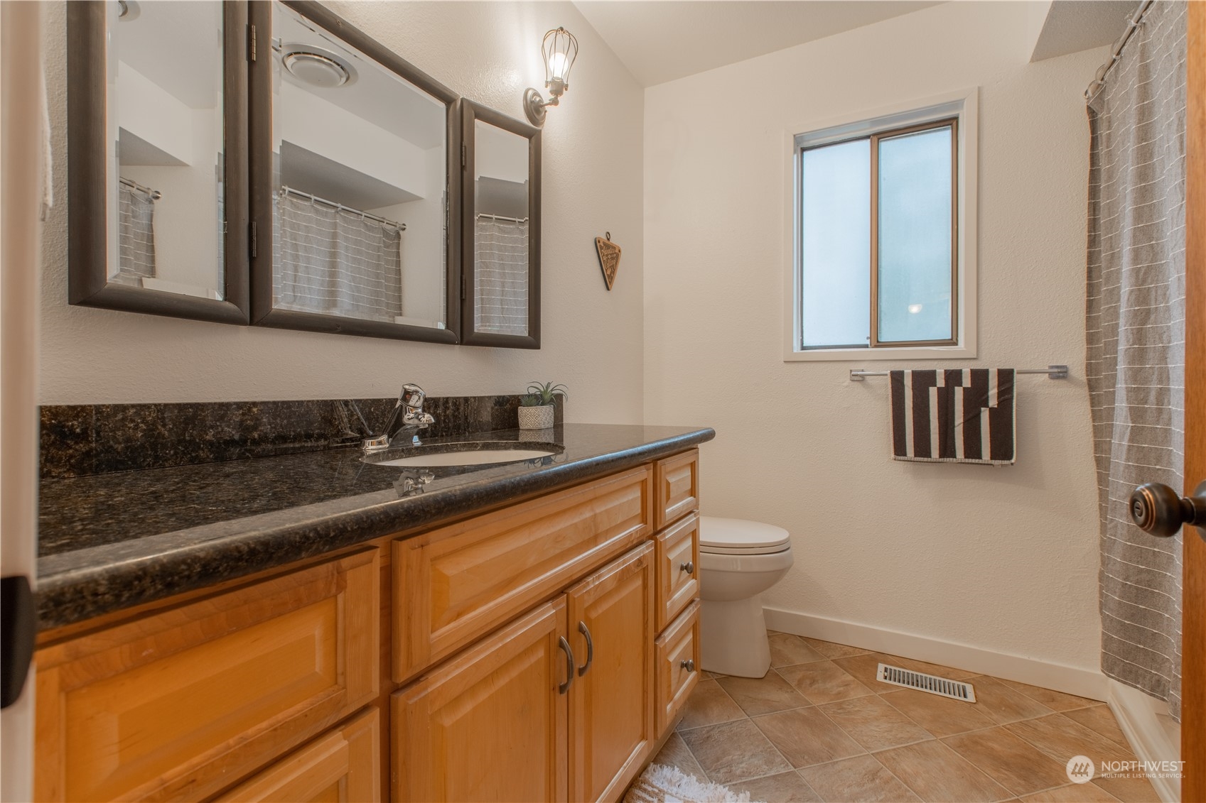 7736 View Ridge Drive Maple Falls, WA 98266 - Photo 17 of 25 a bathroom with a granite countertop sink toilet and mirror