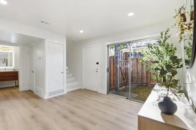 a living room with furniture and a potted plant