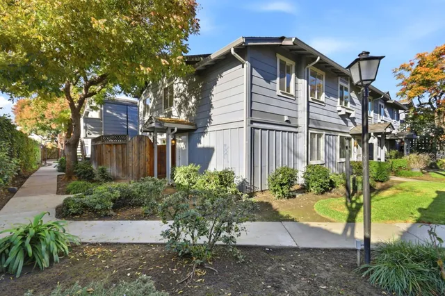 a front view of a house with a yard and outdoor seating