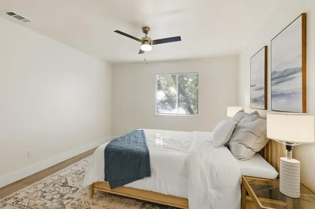 a bedroom with a bed and a window