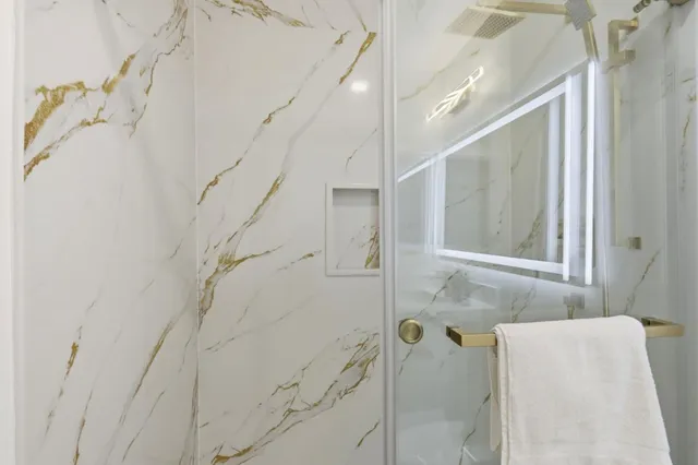 a bathroom with a bathtub and shower