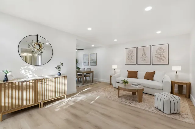 a living room with furniture and a wooden floor