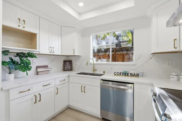 a kitchen with white cabinets and white appliances