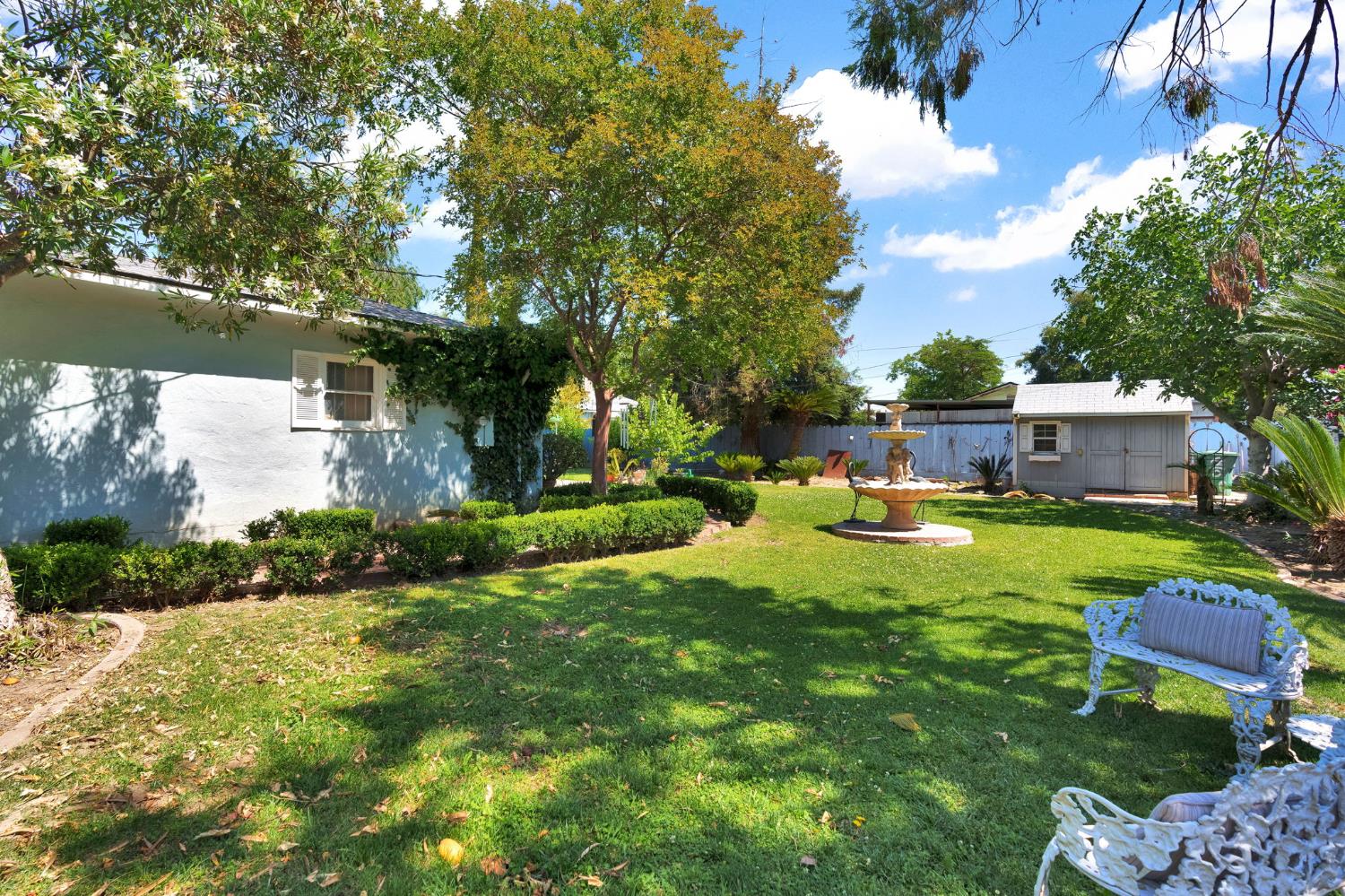 200 Lyons Street Madera, CA 93638 - Photo 32 of 32 a view of a garden with a house in the background