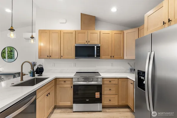 a kitchen with a sink appliances and cabinets