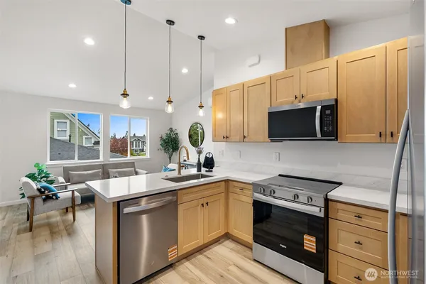 a kitchen with a sink stove and microwave
