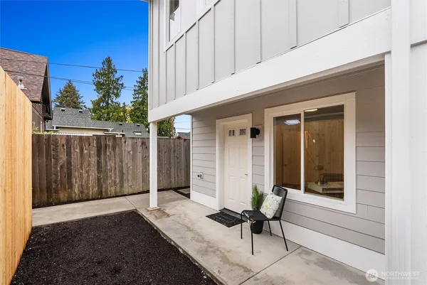 a view of a chairs and table in backyard
