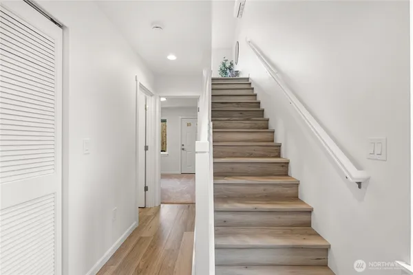 a view of entryway and gallery with wooden floor