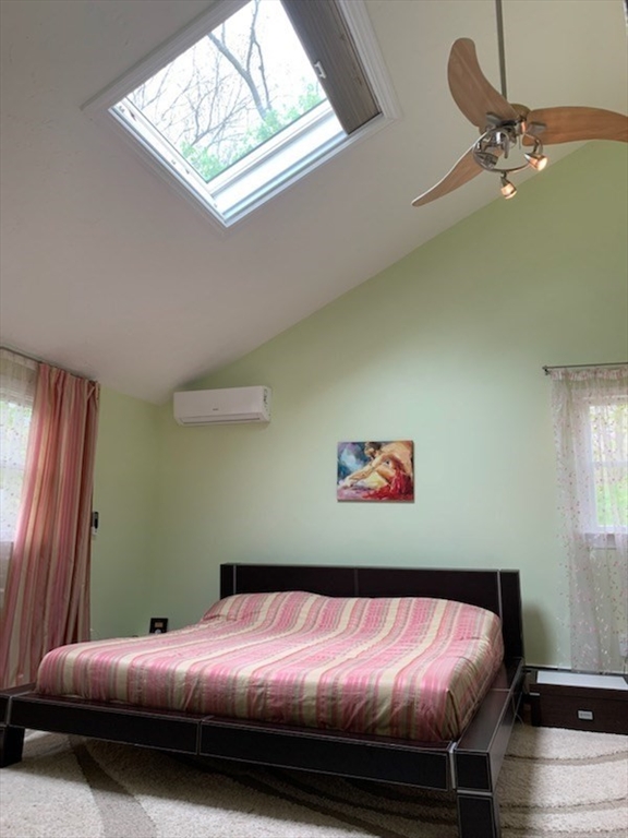 31 Hunnewell Street, Unit 31 Needham, MA 02494 - Photo 13 of 21 a bed sitting in a bedroom next to a window