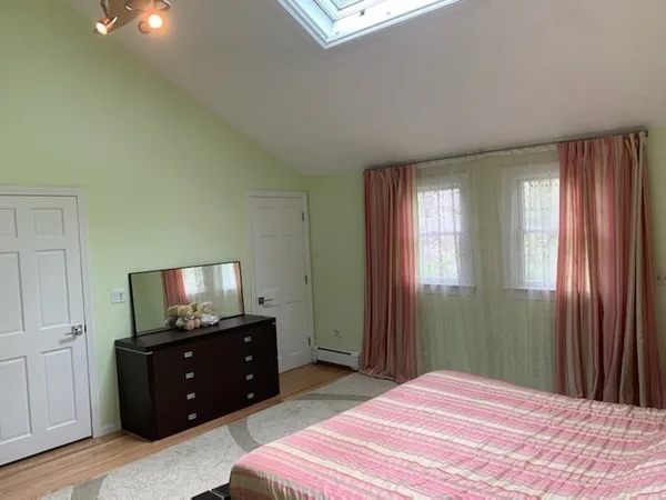 a bedroom with a bed and a television