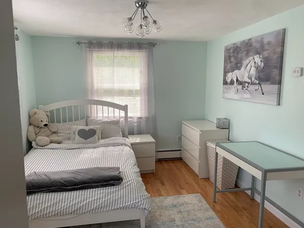 a bedroom with a bed and a chandelier