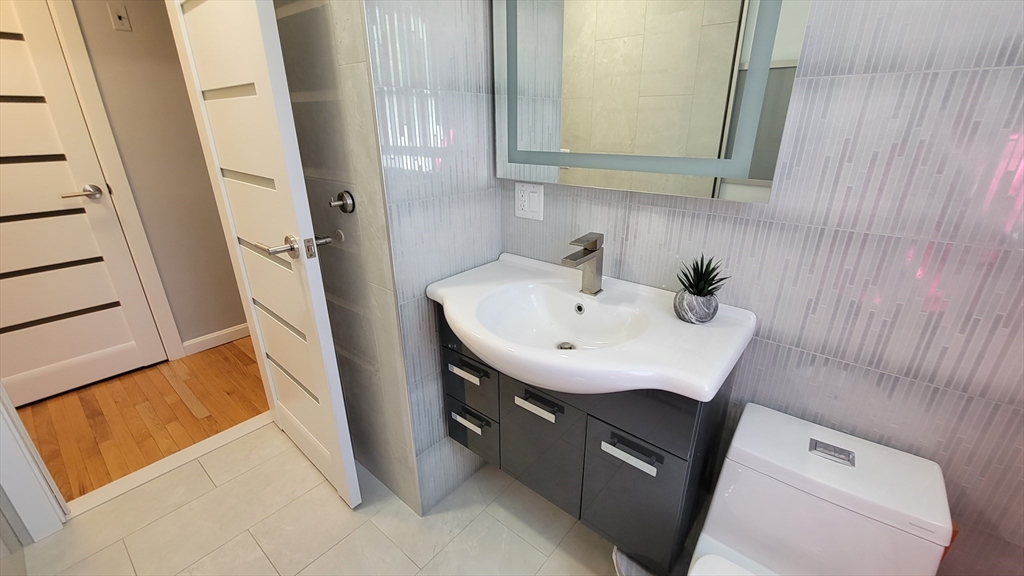 31 Hunnewell Street, Unit 31 Needham, MA 02494 - Photo 19 of 21 a bathroom with a sink and a mirror