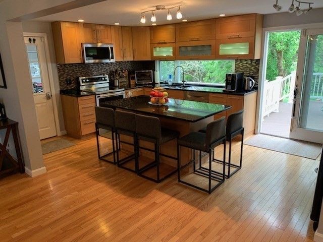 31 Hunnewell Street, Unit 31 Needham, MA 02494 - Photo 5 of 21 a room with stainless steel appliances wooden floor large windows and wooden floor