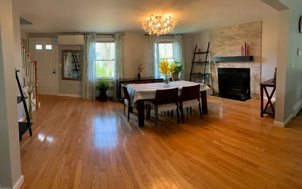 a view of a dining room with furniture window and wooden floor