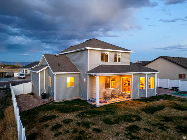 836 South 250 West Vernal, UT 84078 - Photo 3 of 56 Back of house with a fenced backyard, a shingled roof, and a patio