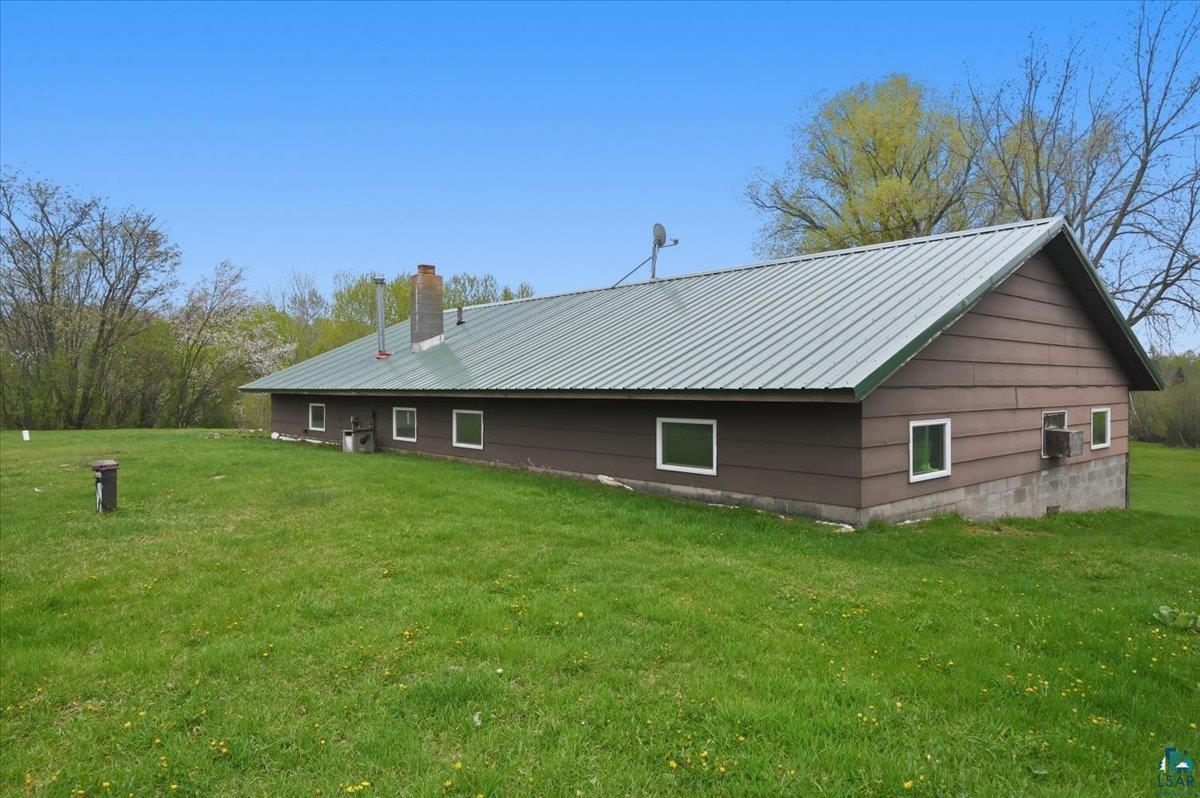 5190 County Road M Gordon, WI 54838 - Photo 4 of 31 Ranch-style structure with a green metal roof and brown siding