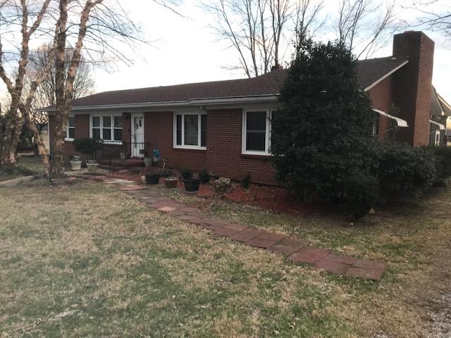 6833 North Pinson Road Portland, TN 37148 - Photo 1 of 18 a front view of house with yard and trees in the background