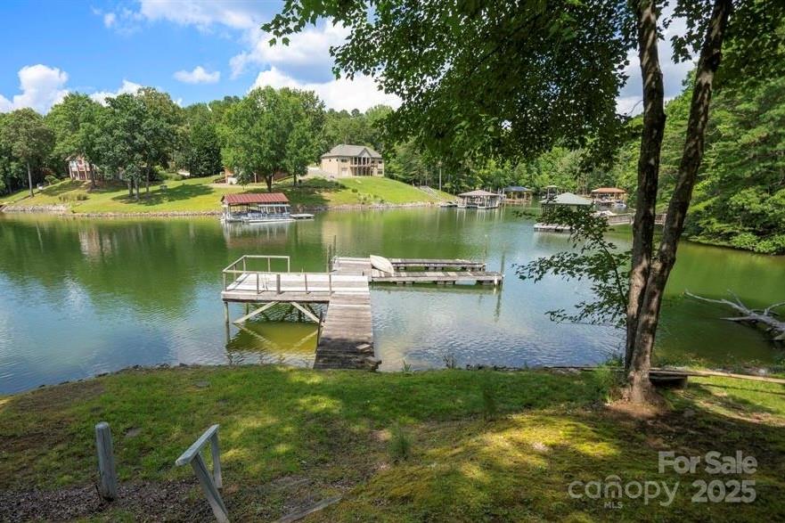 120 Saxton Trail Troutman, NC 28166 - Photo 3 of 7 a view of a lake with a yard and a large tree