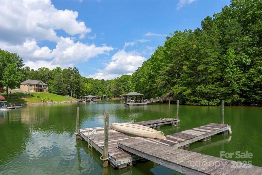 120 Saxton Trail Troutman, NC 28166 - Photo 4 of 7 a view of a lake with a wooden deck and lake