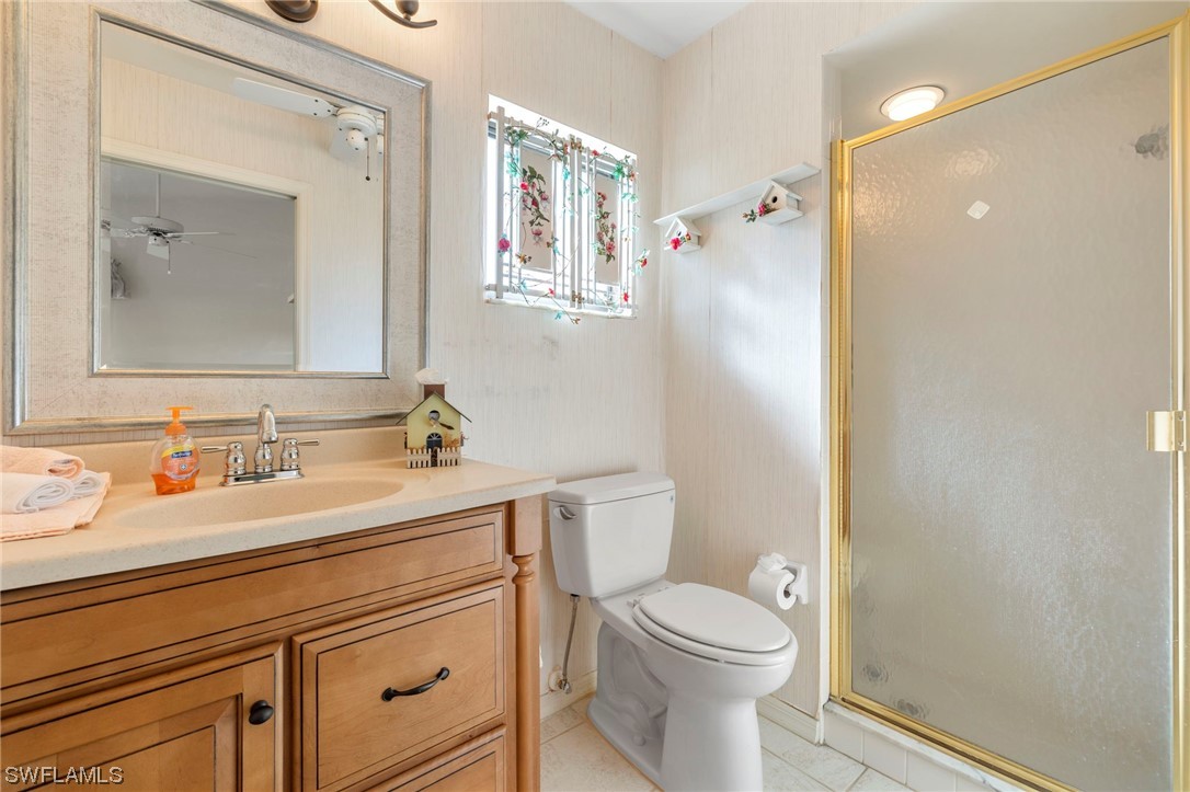 13285 Heather Ridge Loop Fort Myers, FL 33966 - Photo 21 of 47 a bathroom with a granite countertop sink mirror vanity and toilet