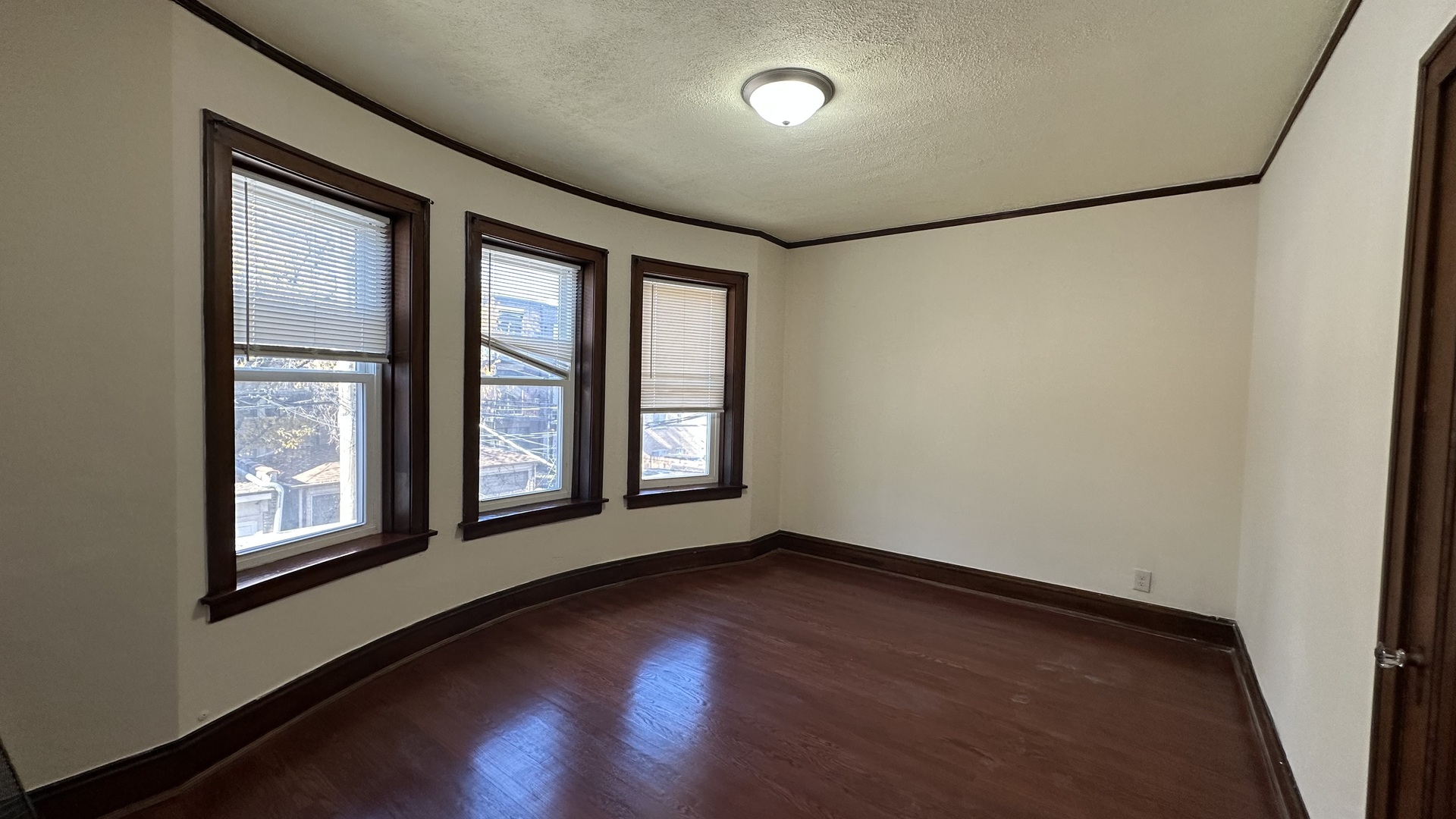 5530 North Artesian Avenue, Unit 1 Chicago, IL 60625 - Photo 16 of 16 an empty room with wooden floor and windows