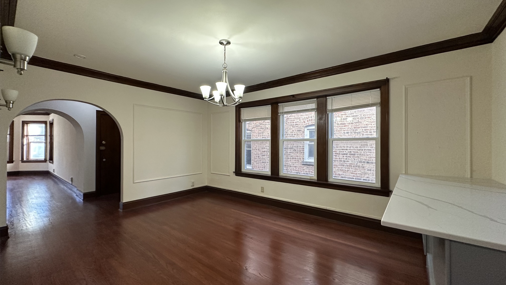 5530 North Artesian Avenue, Unit 1 Chicago, IL 60625 - Photo 10 of 16 a view of an empty room with wooden floor and a window
