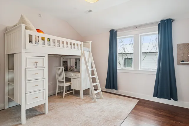 a view of a bedroom with furniture and window
