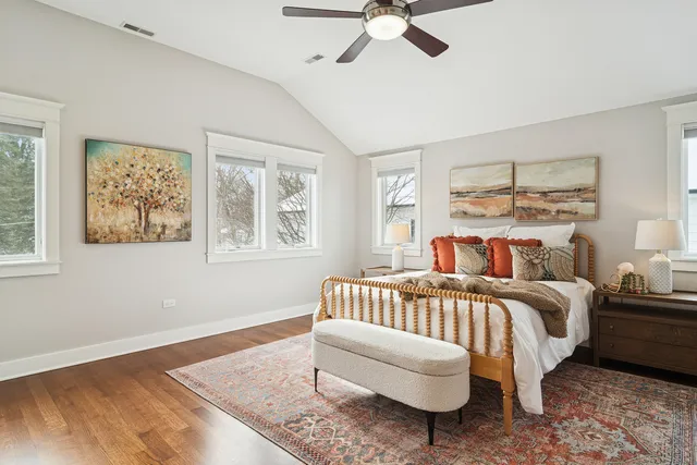 a bedroom with a bed lamp and a window