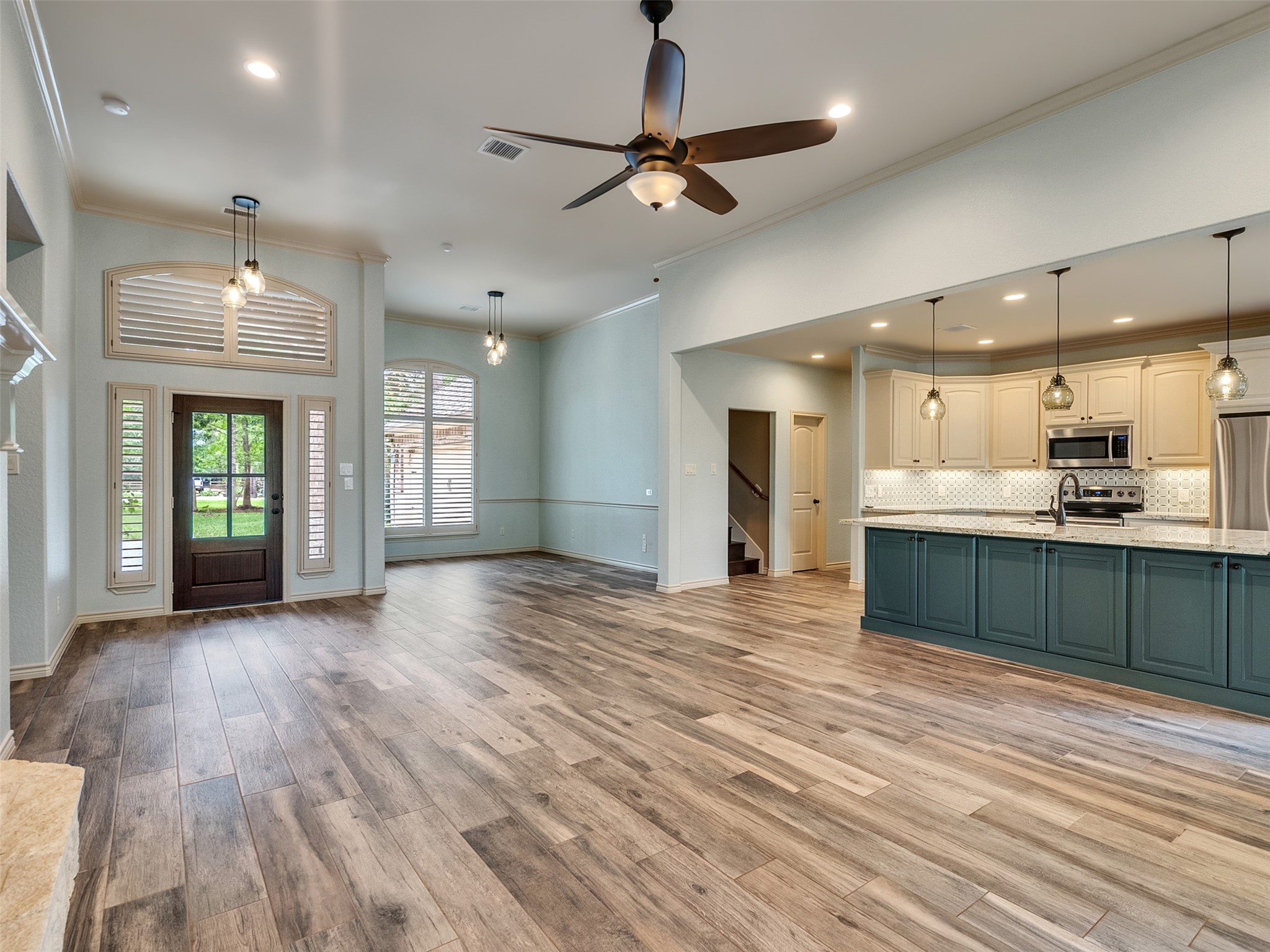 18005 Cindy Lane Conroe, TX 77302 - Photo 13 of 49 Brightened by large windows and a glass-paneled front door, providing plenty of natural light. High ceilings and a ceiling fan enhance the airy feel.