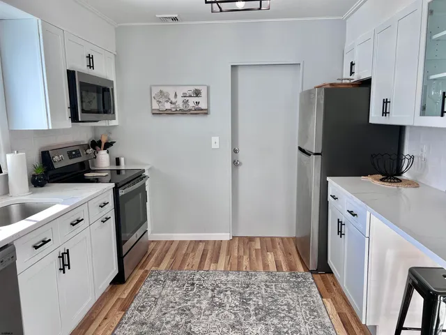 a kitchen with a sink and refrigerator
