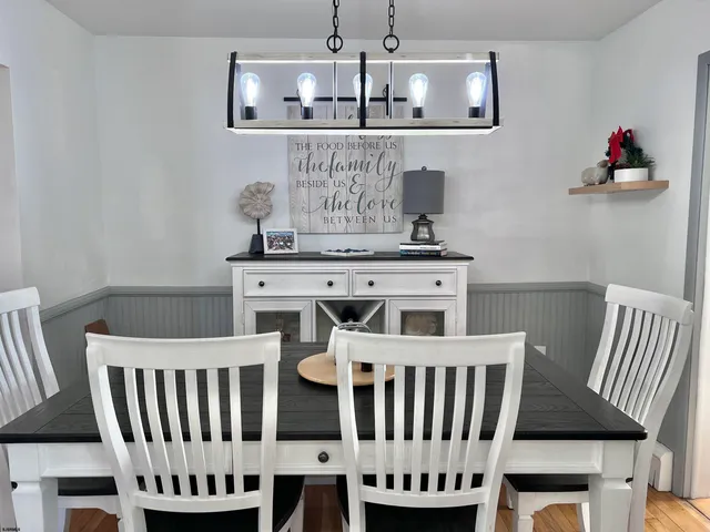 a view of a dining room with furniture wooden floor and chandelier