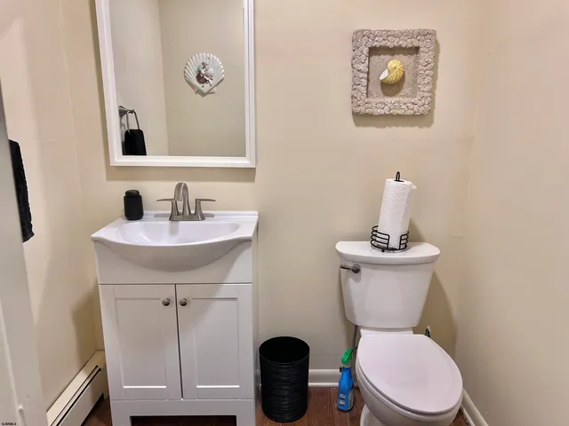 a bathroom with a toilet a sink and mirror