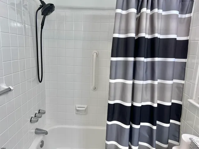 a bathroom with a bathtub and shower