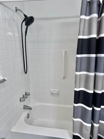 a bathroom with a shower and a bathtub
