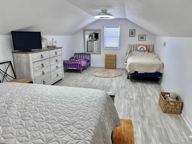 a bedroom with furniture and a flat screen tv