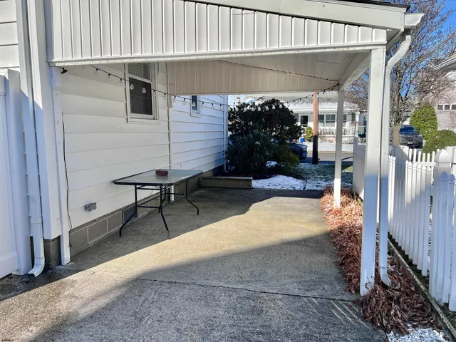 a view of a porch with furniture and a yard